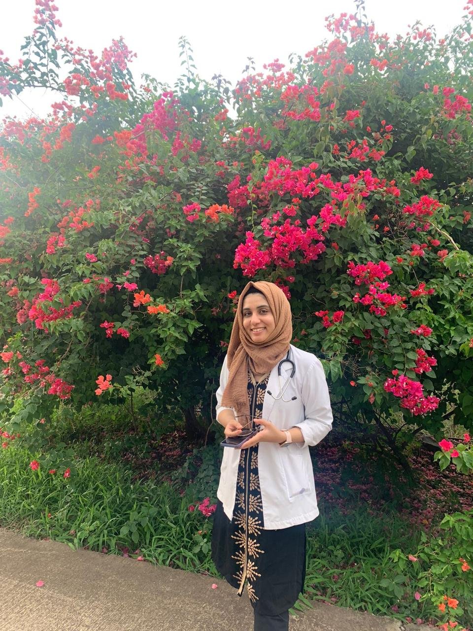 In white coat outdoors